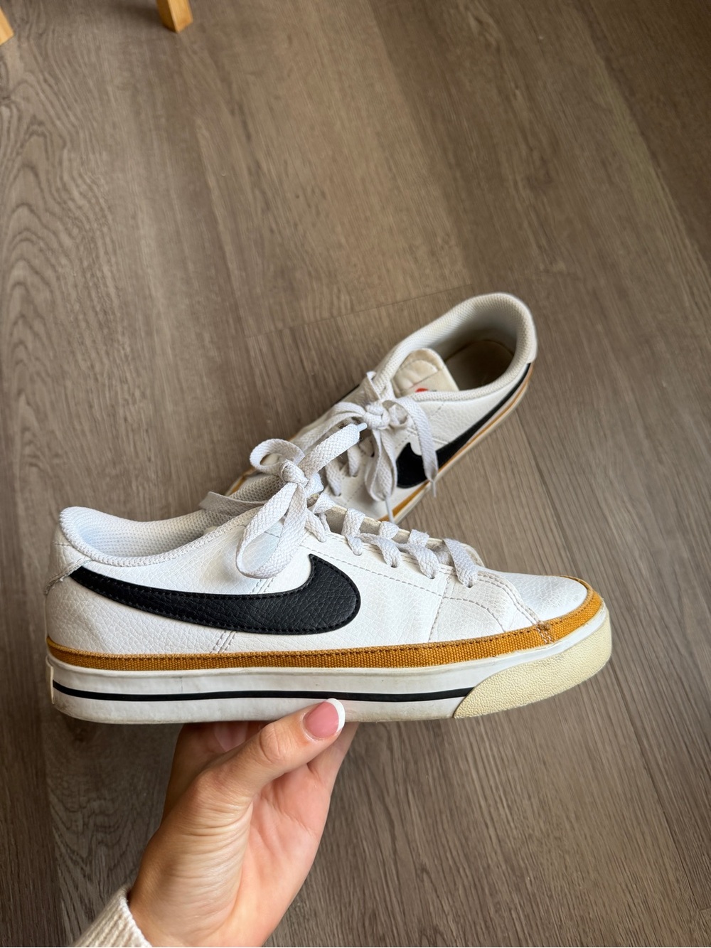 Nike Women’s White Canvas Sneaker with Black Swoosh and Gold Trim